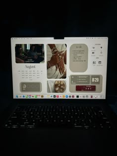 an open laptop computer sitting on top of a black table next to a dark background