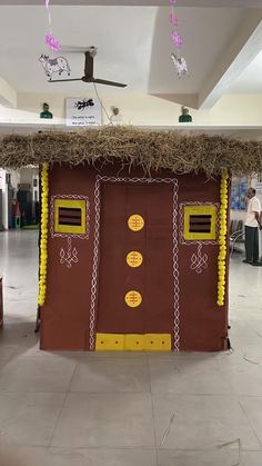 a building made out of cardboard with hay on top