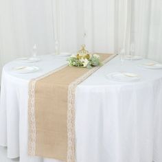 the table is set with white and beige linens