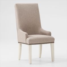 an upholstered chair with nail - tipped trimmings on the legs and back