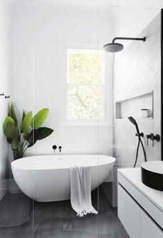 a white bath tub sitting next to a window