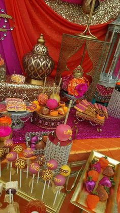 a table topped with lots of cakes and desserts