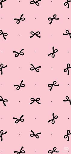 a pink background with black bows and dots