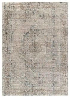 an area rug with faded colors and patterns on the bottom, in greys and browns