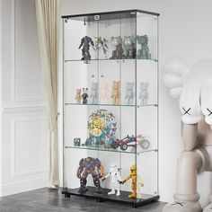 a glass display case filled with lots of toy figurines