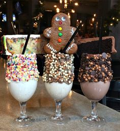 three glasses filled with different types of desserts on top of a table next to each other