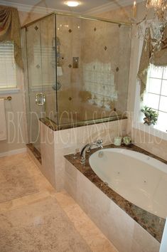 a bathroom with a large tub and walk in shower