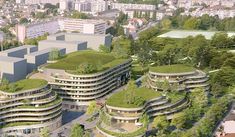 an aerial view of a green city with buildings and trees in the foreground, surrounded by greenery