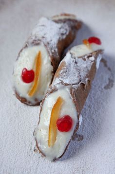 two pastries with fruit on them sitting in the snow