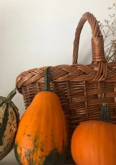 some gourds and pumpkins in a wicker basket