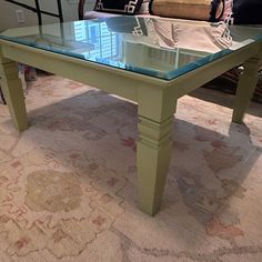 a coffee table with glass top in a living room