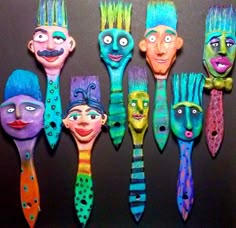 many different colored toothbrushes with faces painted on them