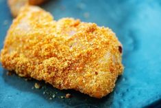 a fried chicken breast on a blue plate