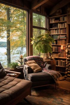 a living room filled with furniture next to a window covered in lots of books and plants