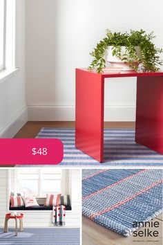 a red table sitting on top of a blue rug next to a white wall and window