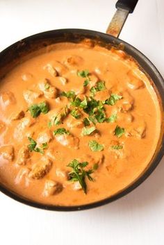 a skillet filled with food on top of a white table