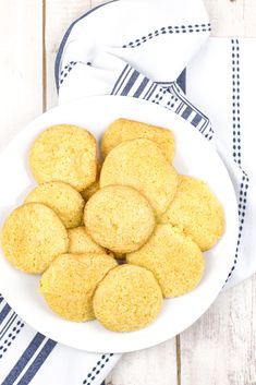 a white bowl filled with cookies sitting on top of a blue and white table cloth