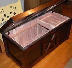 an open wooden box sitting on top of a hard wood floor