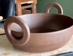 a large brown bowl sitting on top of a table