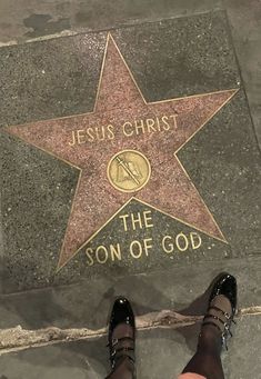 a person standing next to a star on the ground