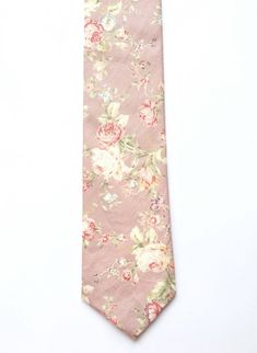 DESCRIPTION: This stunning men's skinny tie has been handmade using a gorgeous soft pinky mauve floral cotton.FABRIC: Cotton.LINING FABRIC: Cotton.--------------------------------------------------------------------------------------------DETAILS:• Made the traditional way with fabric cut on the bias• Each tie has canvas lining throughout• Fabric lining just at the tip on each end of the tie• Width at the widest part measures approx 2.5 inches• The length of each tie is approx 58 Inches• Comes p Blue Suit Pink Tie, Pink Tie Wedding, Slim Fit Groom Suit, Blush Pink Tie, Groomsmen Colours, Mens Floral Tie, Blush Pink Ties, Blush Wedding Colors, Blue Suit Wedding