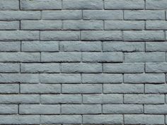 a gray brick wall with no mortar