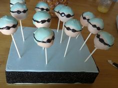 cake pops with blue frosting and black eyeballs on them sitting on a table