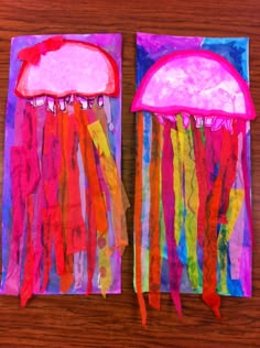 two paper bags with jellyfishs on them sitting on top of a wooden table