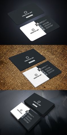 some black and white business cards on a table