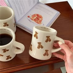 two coffee mugs with teddy bears on them