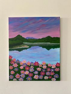 a painting on the wall of a lake with flowers in front of it and mountains in the background