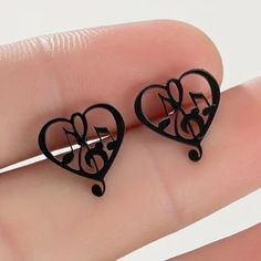 Unique Music Notes And Treble Clef In A Heart Black Stud Earrings. Perfect For Any Musician Or Music Lover. Also Available In Gold Toned, Rose Gold Toned And Silver Toned. Black Valentine's Day Earrings, Black Metal Earrings For Valentine's Day, Black Heart Earrings As A Gift, Black Heart Earrings For Pierced Ears As Gift, Black Metal Heart Earrings, Black Earrings For Valentine's Day, Black Music-themed Jewelry For Gift, Music-themed Black Jewelry Gift, Treble Clef Heart