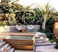 two chairs sitting on top of a wooden deck