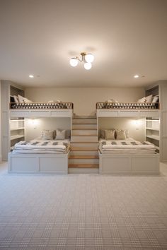 a room with bunk beds and stairs in it