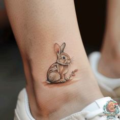 a small rabbit tattoo on the ankle