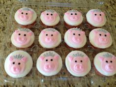 twelve cupcakes with pink frosting in a plastic container