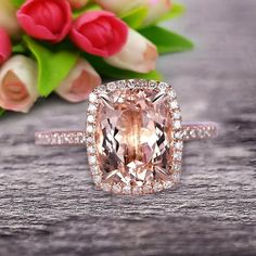 an engagement ring with a fancy cushion cut peach sapphire surrounded by pave and diamonds