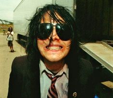 a man with black hair wearing sunglasses and a tie