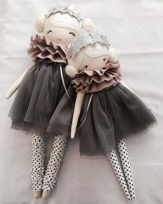 a stuffed animal doll wearing a dress and polka dot tights on a white sheet