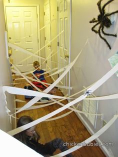 two children are sitting on the floor in front of halloween decorations