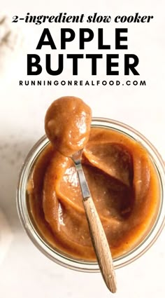 an apple butter in a glass jar with a wooden spoon on the side and text overlay that reads, 3 ingredient slow cooker apple butter