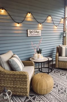 two wicker chairs sitting on top of a rug next to a table and chair