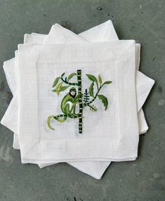 four embroidered napkins on top of each other