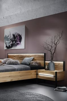 a large bed sitting next to a painting on the wall in a room with purple walls