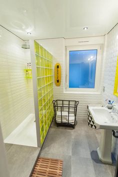 a bathroom with yellow and white tiles on the walls