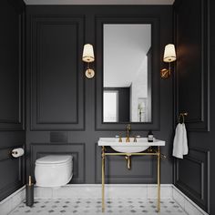 an elegant bathroom with black walls and gold fixtures, white toilet and sink in the corner