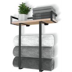 a shelf with towels and a potted plant on it