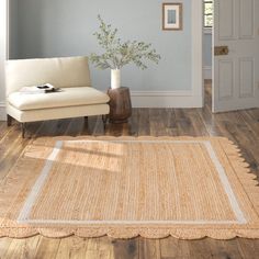 a white couch sitting on top of a hard wood floor next to a wooden table