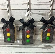 three candy bags with black bows and candies in them