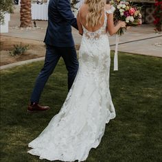 a bride and groom walking down the aisle at their outdoor wedding ceremony in palm springs, florida